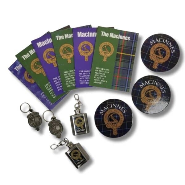 A flat lay showcases a variety of Armstrong Clan-themed items, including books, keychains, and coasters embellished with clan motifs and logos. Discover the heritage of the Armstrong Clan with these beautifully crafted pieces.