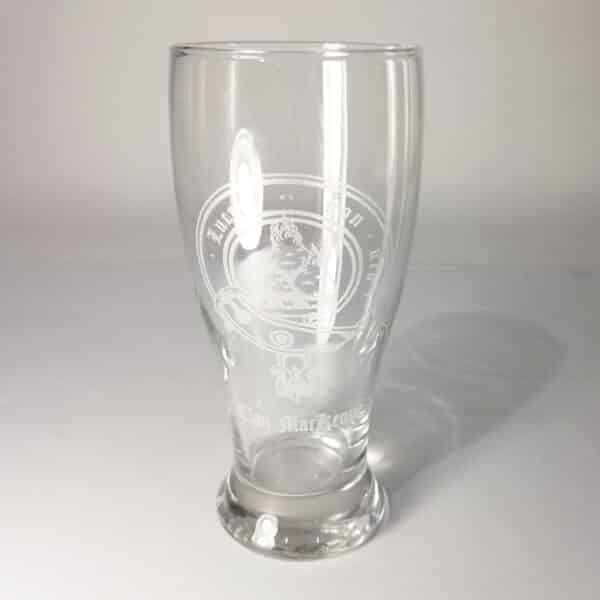 The MacKenzie Clan Crest 19 oz Pilsner Glass showcases clear glass with an etched crest design and detailed emblem, making it ideal for pilsner enthusiasts.