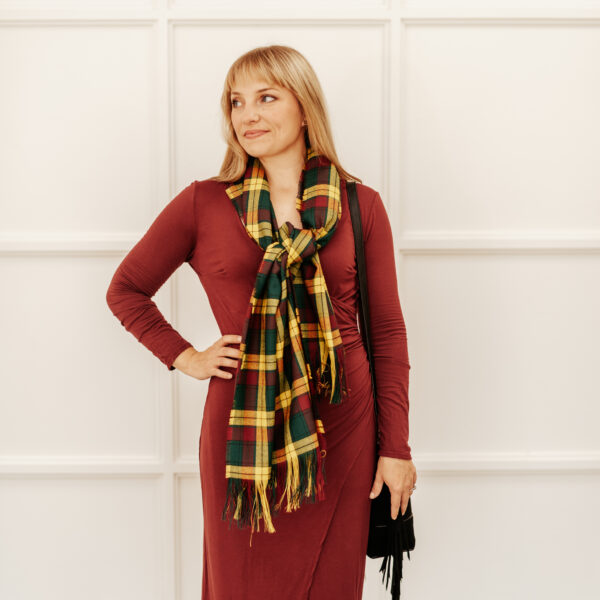 A woman wearing a Tartan Scarf - Homespun Wool Blend and black dress.